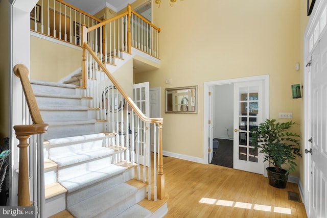 1597 Woodfield Dr, Bethlehem, PA 18015 - staircase featuring a towering ceiling, wood finished floors, and baseboards