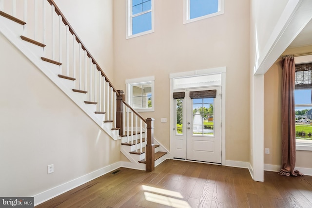 24153 Heartleaf Rd, Frankford, DE 19945 - foyer entrance featuring hardwood / wood-style floors, a high ceiling, healthy amount of natural light, and stairway