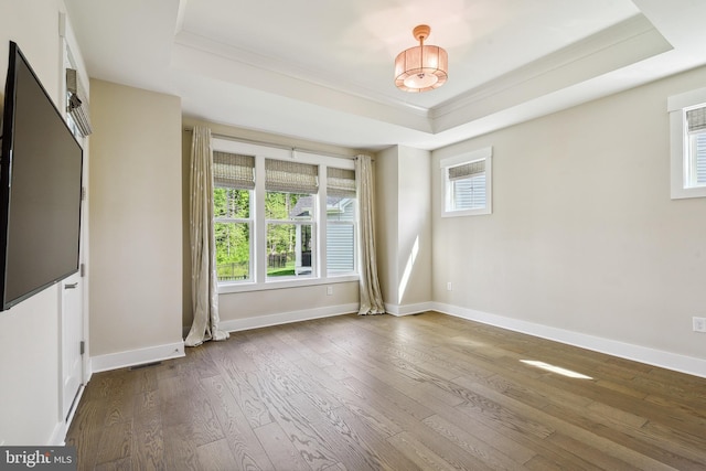 24153 Heartleaf Rd, Frankford, DE 19945 - empty room featuring a raised ceiling, ornamental molding, dark wood-style flooring, and baseboards