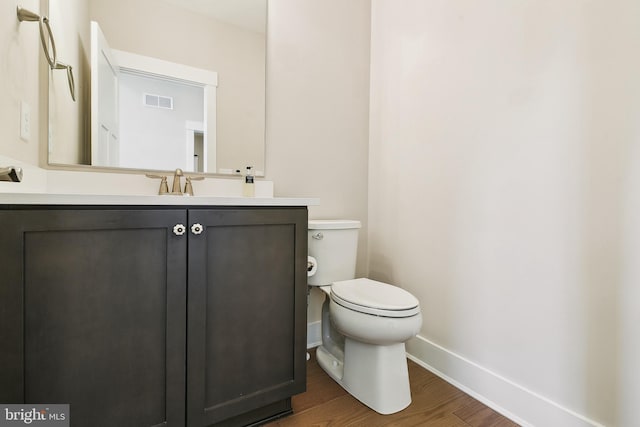 24153 Heartleaf Rd, Frankford, DE 19945 - half bathroom with baseboards, toilet, wood finished floors, and vanity