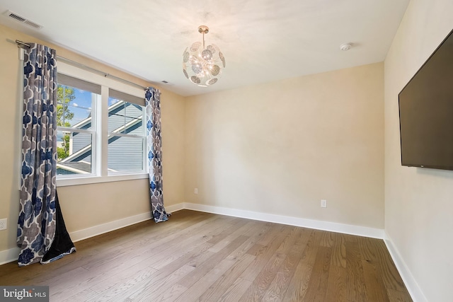 24153 Heartleaf Rd, Frankford, DE 19945 - unfurnished room featuring wood finished floors, a chandelier, baseboards, and a smoke detector