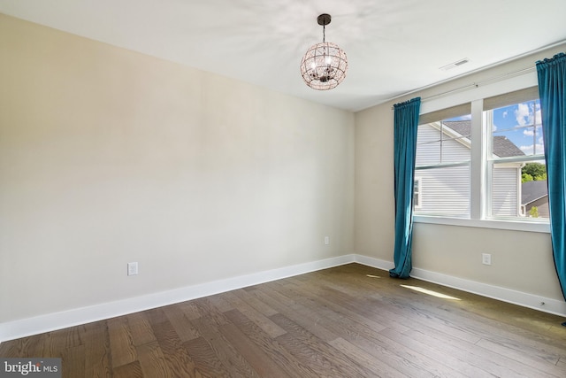 24153 Heartleaf Rd, Frankford, DE 19945 - empty room featuring a chandelier, dark wood finished floors, and baseboards