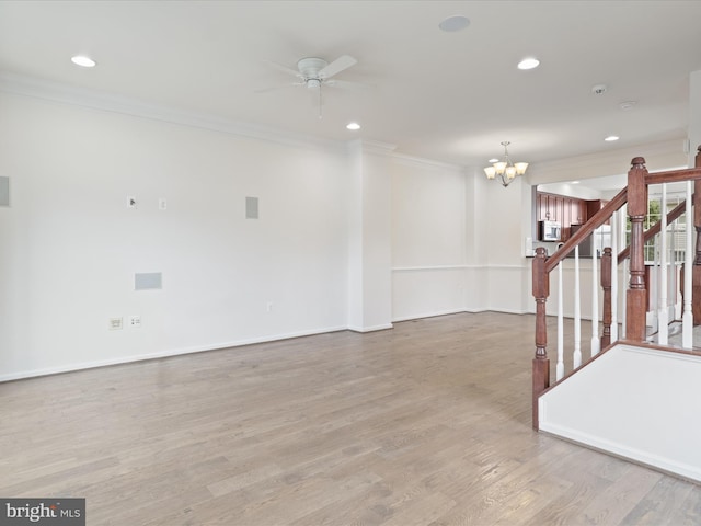 43167 Loudoun Reserve Dr, Ashburn, VA 20148 - empty room with ornamental molding, a chandelier, ceiling fan, wood finished floors, and stairway