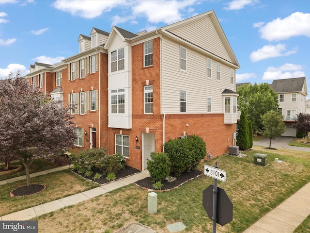 43167 Loudoun Reserve Dr, Ashburn, VA 20148 - view of front of home featuring brick siding, cooling unit, and a front lawn