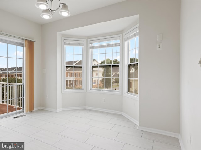 43167 Loudoun Reserve Dr, Ashburn, VA 20148 - empty room featuring healthy amount of natural light, a chandelier, and baseboards