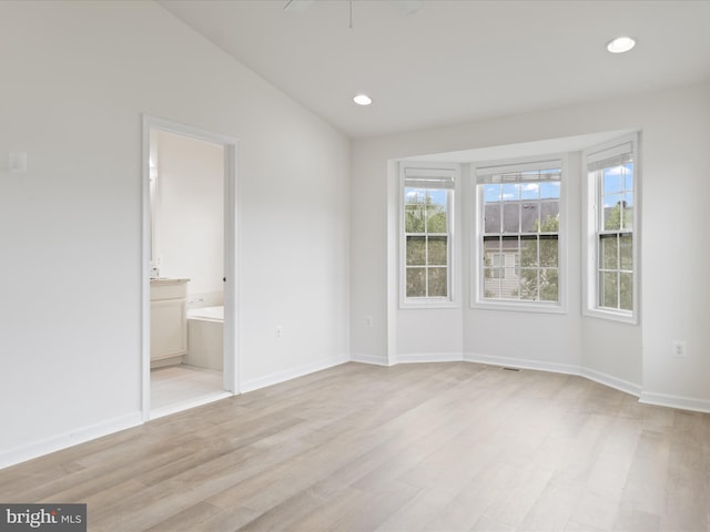 43167 Loudoun Reserve Dr, Ashburn, VA 20148 - unfurnished bedroom with light wood-type flooring, recessed lighting, baseboards, vaulted ceiling, and ensuite bathroom
