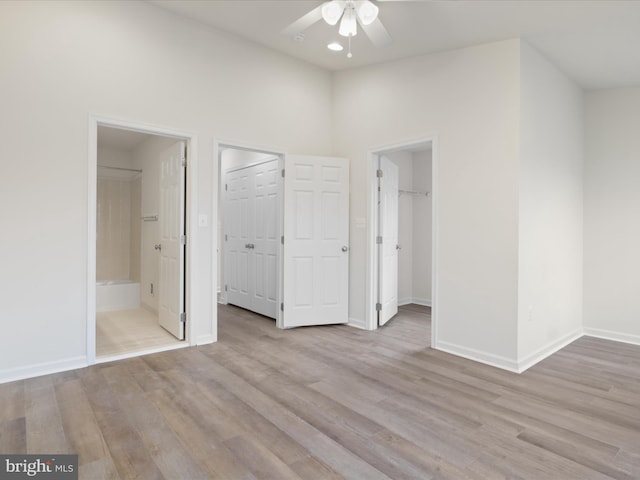 43167 Loudoun Reserve Dr, Ashburn, VA 20148 - unfurnished bedroom with wood finished floors, baseboards, a spacious closet, connected bathroom, and recessed lighting