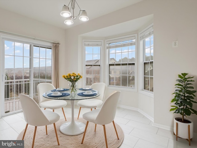43167 Loudoun Reserve Dr, Ashburn, VA 20148 - dining area with light tile patterned flooring, baseboards, and a chandelier