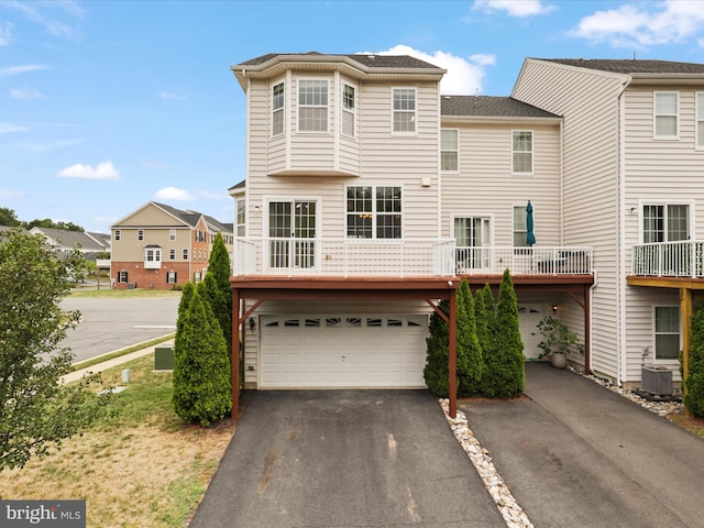 43167 Loudoun Reserve Dr, Ashburn, VA 20148 - view of front facade with a garage, asphalt driveway, a residential view, and central AC