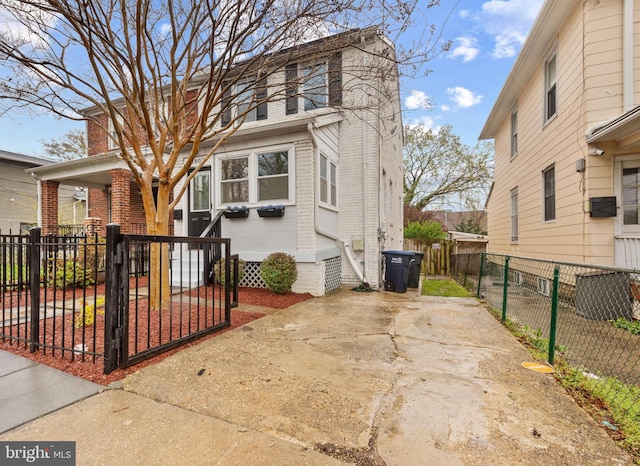 2802 Bruce Pl SE, Washington, DC 20020 - view of front facade with brick siding, a fenced front yard, and covered porch