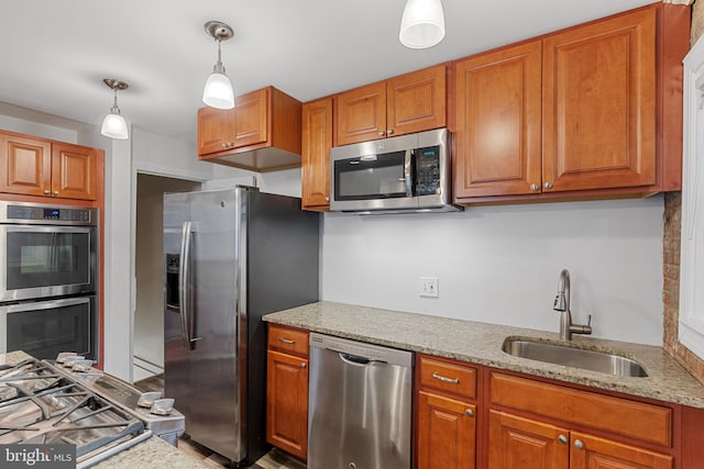 2802 Bruce Pl SE, Washington, DC 20020 - kitchen featuring stainless steel appliances, a sink, and brown cabinetry