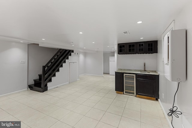 2802 Bruce Pl SE, Washington, DC 20020 - kitchen featuring beverage cooler, freestanding refrigerator, recessed lighting, baseboards, and glass insert cabinets