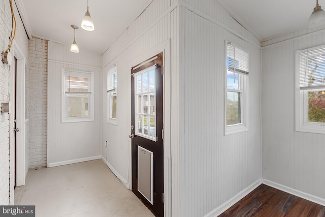2802 Bruce Pl SE, Washington, DC 20020 - foyer featuring healthy amount of natural light, baseboards, brick wall, and ornamental molding