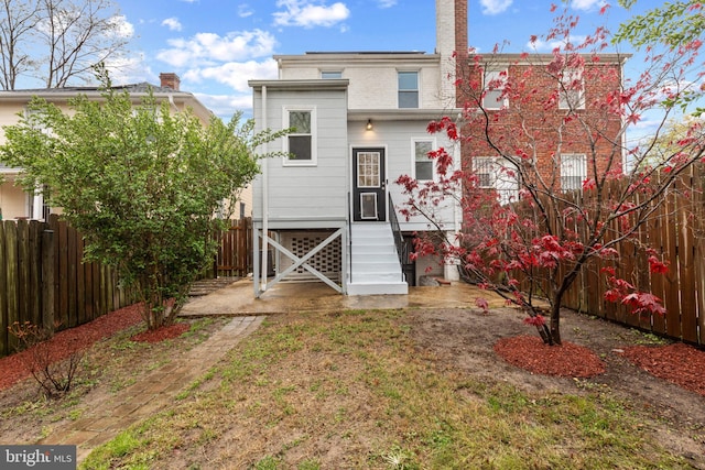 2802 Bruce Pl SE, Washington, DC 20020 - back of house with entry steps and a fenced backyard