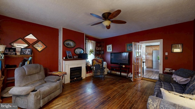 5403 Willow Grove Rd, Camden Wyoming, DE 19934 - living area with a ceiling fan, hardwood / wood-style flooring, a fireplace, a textured ceiling, and baseboards