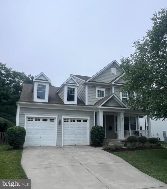 415 Yeonas Dr SW, Vienna, VA 22180 - view of front facade with concrete driveway, covered porch, a front lawn, and an attached garage