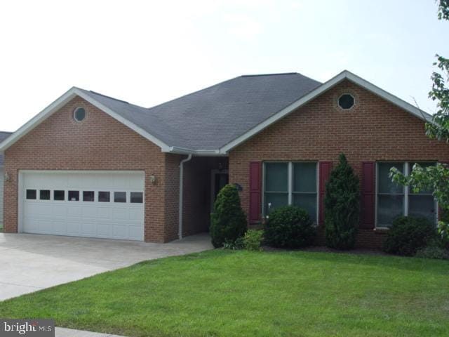 1419 Ramseur Ln, Winchester, VA 22601 - view of front of house featuring brick siding, an attached garage, driveway, and a front yard