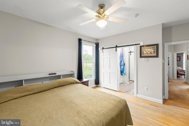 1419 Ramseur Ln, Winchester, VA 22601 - bedroom with light wood-style floors, baseboards, a barn door, and a ceiling fan