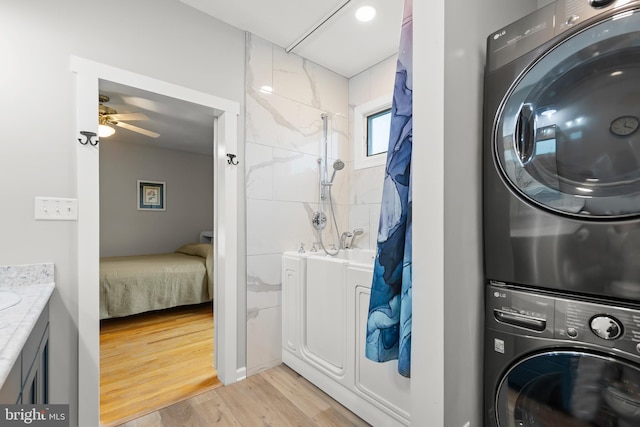 1419 Ramseur Ln, Winchester, VA 22601 - washroom with stacked washer / drying machine, light wood finished floors, and a ceiling fan