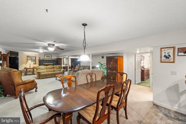 1419 Ramseur Ln, Winchester, VA 22601 - dining area featuring light carpet, a ceiling fan, a fireplace, and baseboards