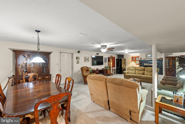 1419 Ramseur Ln, Winchester, VA 22601 - dining area featuring a tiled fireplace, light carpet, and ceiling fan