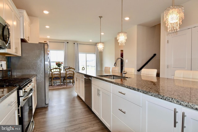 35258 Wright Way, Millsboro, DE 19966 - kitchen featuring a chandelier, appliances with stainless steel finishes, a sink, white cabinetry, and dark stone countertops