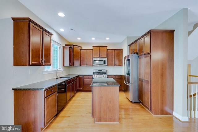 124 Mary Ambler Way, Ambler, PA 19002 - kitchen with stainless steel appliances, a kitchen island, light wood-type flooring, dark stone counters, and recessed lighting