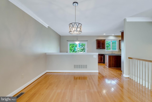 124 Mary Ambler Way, Ambler, PA 19002 - unfurnished dining area with light wood-type flooring, a chandelier, baseboards, crown molding, and a sink