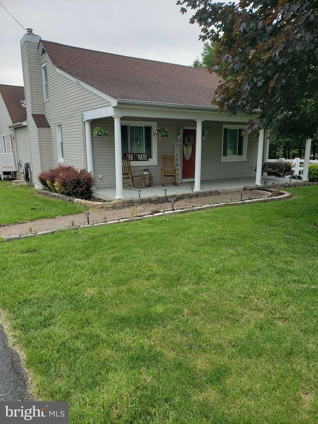 4010 Conowingo Rd, Darlington, MD 21034 - view of front facade featuring covered porch, a front lawn, a shingled roof, and a chimney