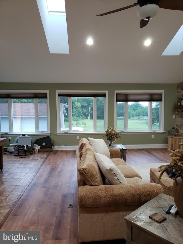 4010 Conowingo Rd, Darlington, MD 21034 - living room with a skylight, vaulted ceiling, a ceiling fan, wood finished floors, and baseboards
