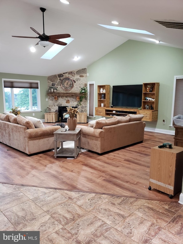 4010 Conowingo Rd, Darlington, MD 21034 - living area featuring a skylight, a stone fireplace, ceiling fan, wood finished floors, and high vaulted ceiling