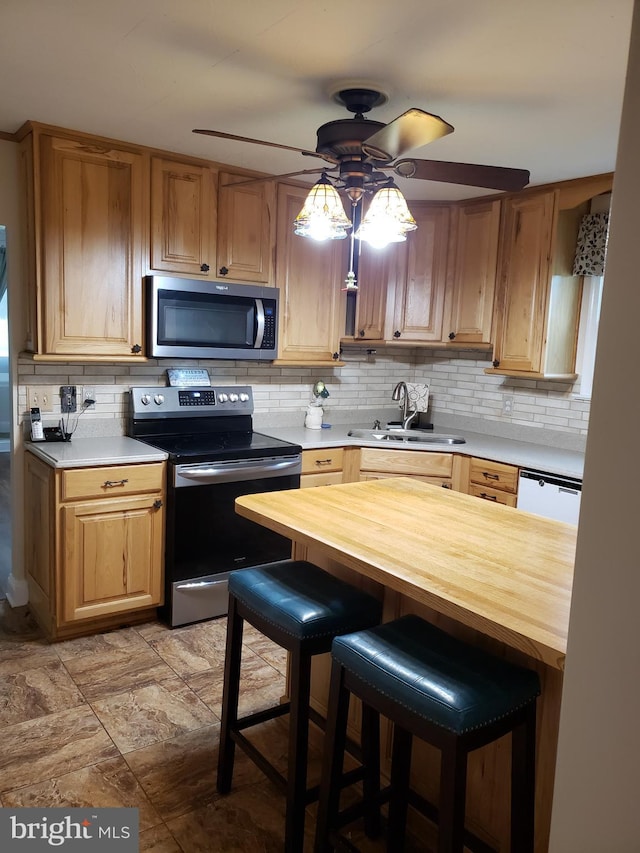 4010 Conowingo Rd, Darlington, MD 21034 - kitchen with stainless steel appliances, a sink, wooden counters, a ceiling fan, and tasteful backsplash