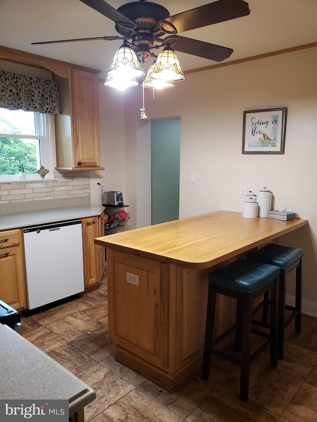 4010 Conowingo Rd, Darlington, MD 21034 - kitchen with white dishwasher, a ceiling fan, decorative backsplash, a breakfast bar area, and wood counters