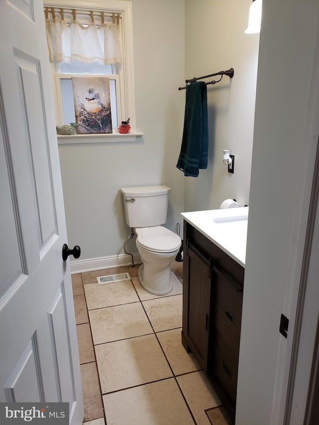 4010 Conowingo Rd, Darlington, MD 21034 - half bath featuring vanity, toilet, tile patterned floors, and baseboards