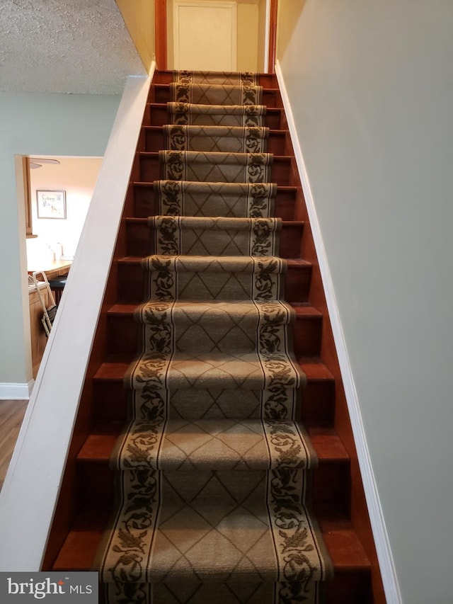 4010 Conowingo Rd, Darlington, MD 21034 - staircase with a textured ceiling and wood finished floors