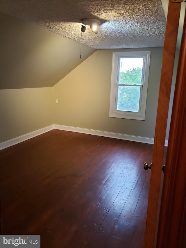 4010 Conowingo Rd, Darlington, MD 21034 - additional living space with baseboards, dark wood-style flooring, a textured ceiling, and lofted ceiling
