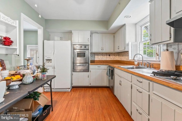605 Oak Ter, Point Pleasant Boro, NJ 08742 - kitchen with stainless steel appliances, a sink, a warming drawer, light wood-style floors, and range hood