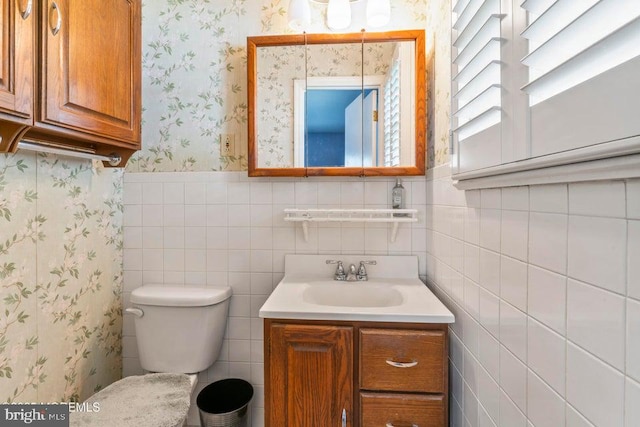 605 Oak Ter, Point Pleasant Boro, NJ 08742 - bathroom with wallpapered walls, vanity, tile walls, toilet, and a wainscoted wall