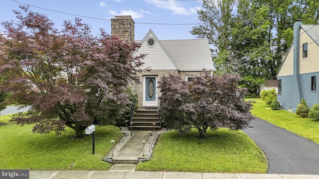 1217 Bullens Ln, Woodlyn, PA 19094 - tudor-style house with a chimney and a front yard