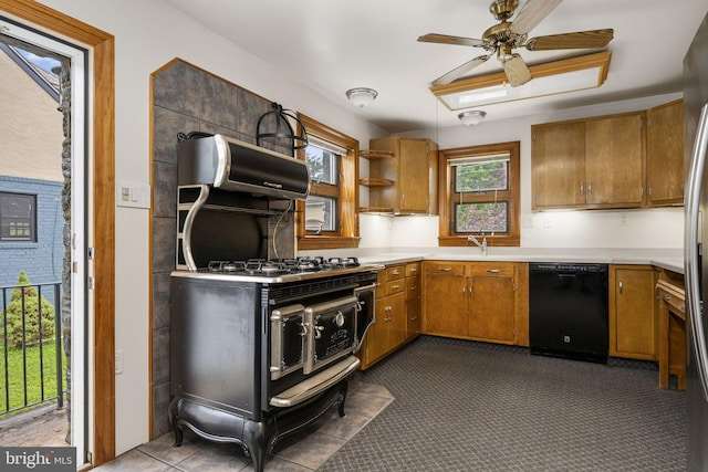 1217 Bullens Ln, Woodlyn, PA 19094 - kitchen with dishwasher, brown cabinetry, and light countertops