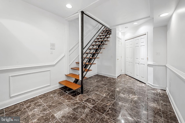 3310 Hudson St, Baltimore, MD 21224 - staircase with marble finish flooring, recessed lighting, a decorative wall, and a wainscoted wall