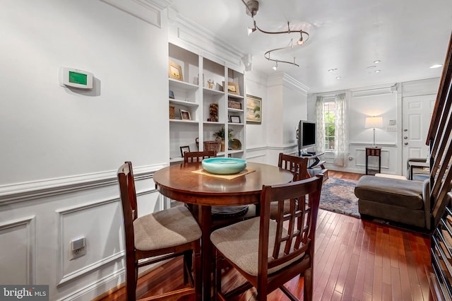 3310 Hudson St, Baltimore, MD 21224 - dining area with a decorative wall, wainscoting, and dark wood-style floors