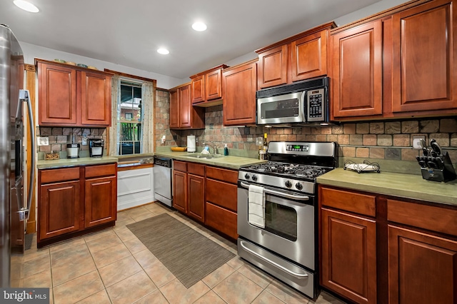 3310 Hudson St, Baltimore, MD 21224 - kitchen with appliances with stainless steel finishes, tasteful backsplash, light tile patterned floors, light countertops, and a sink