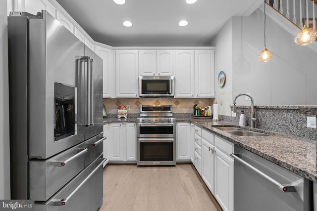 8820 Shining Oceans Way Unit 407, Columbia, MD 21045 - kitchen with appliances with stainless steel finishes, white cabinets, dark stone counters, light wood finished floors, and recessed lighting