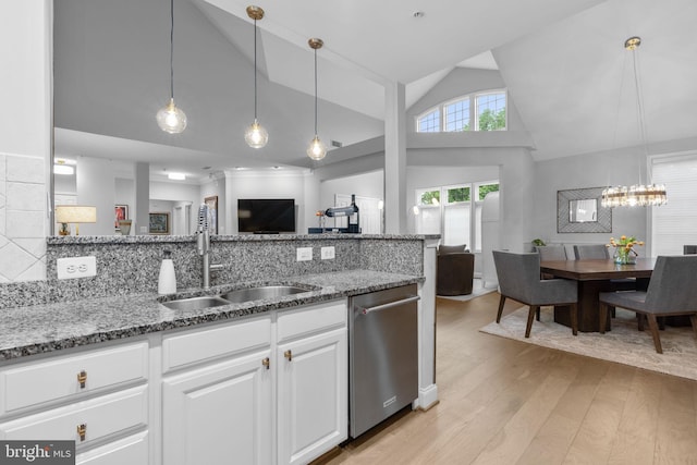 8820 Shining Oceans Way Unit 407, Columbia, MD 21045 - kitchen featuring stainless steel dishwasher, light stone counters, light wood-style flooring, open floor plan, and high vaulted ceiling