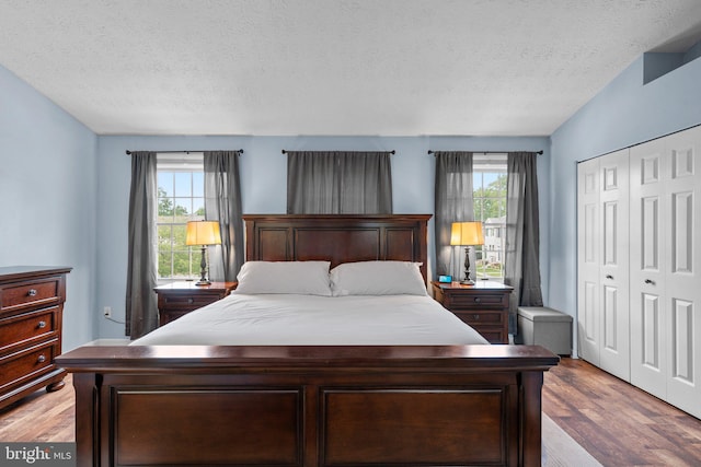 1328 Hollow Glen Ct, Curtis Bay, MD 21226 - bedroom with a textured ceiling, a closet, and wood finished floors
