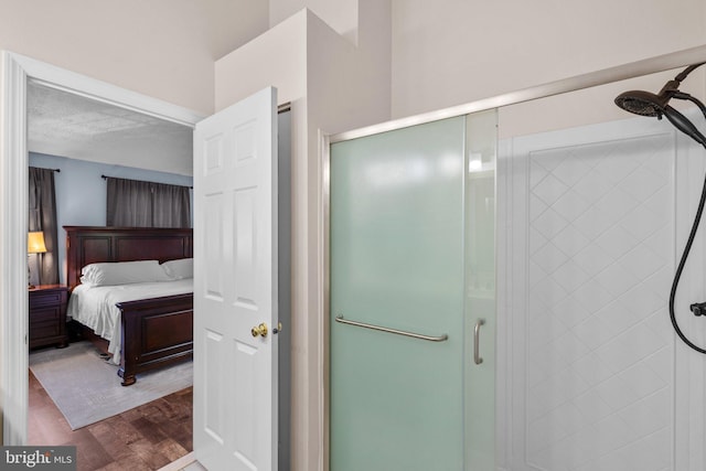 1328 Hollow Glen Ct, Curtis Bay, MD 21226 - ensuite bathroom featuring a stall shower, wood finished floors, and a textured ceiling