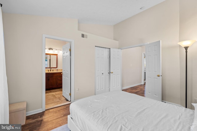 1328 Hollow Glen Ct, Curtis Bay, MD 21226 - bedroom with wood finished floors, baseboards, ensuite bathroom, high vaulted ceiling, and a sink