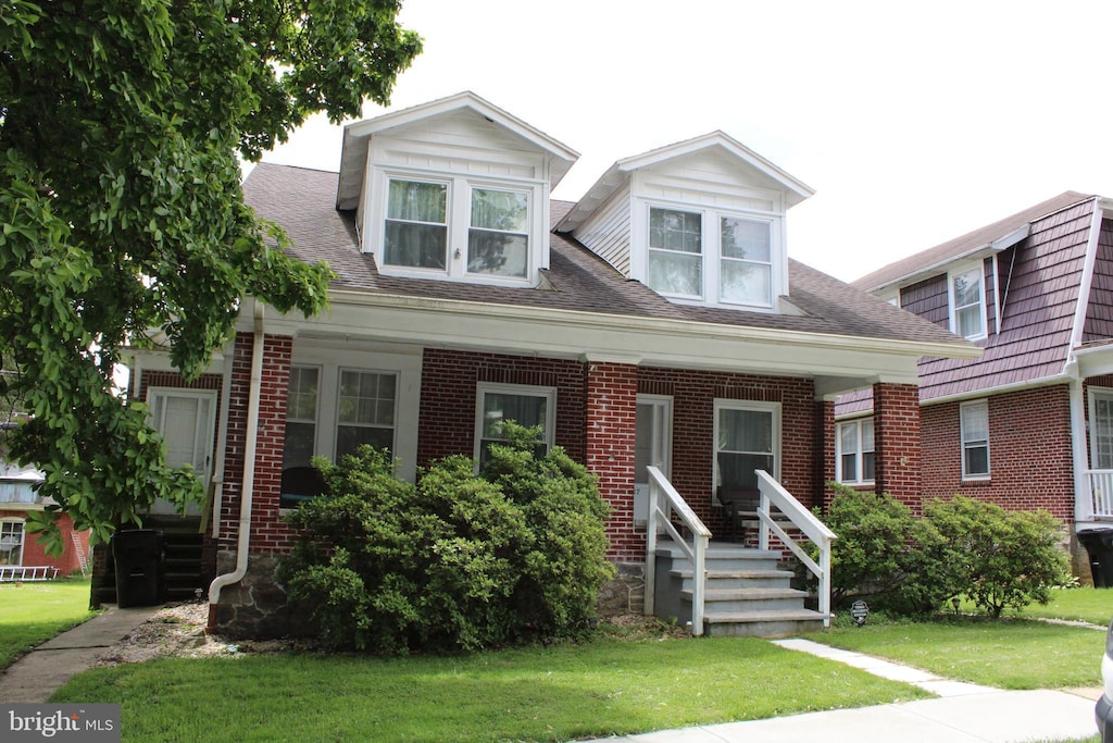 527 N 25th St, Reading, PA 19606 - view of front of property with a front yard, brick siding, and a shingled roof