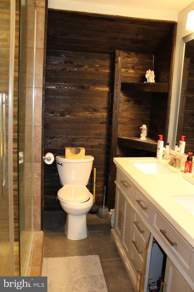 527 N 25th St, Reading, PA 19606 - full bath with double vanity, toilet, tile patterned flooring, wood walls, and a shower with shower door